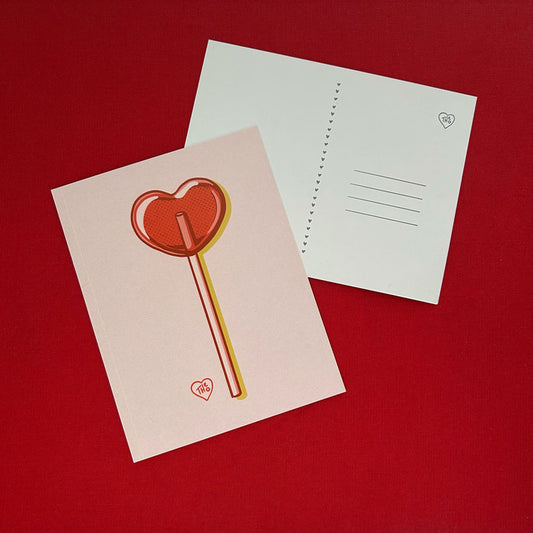 Two postcards on a red background, one with a heart-shaped lollipop design, the other showing the white postcard back with heart motif